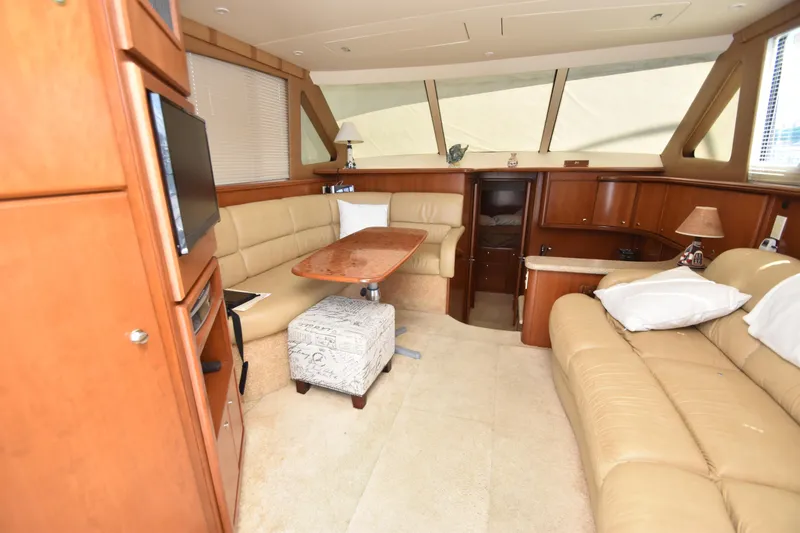 Sea Marie Yacht Photos Pics Luxurious interior of 2007 Silverton 38 Convertible yacht with beige leather seating and wooden accents.
