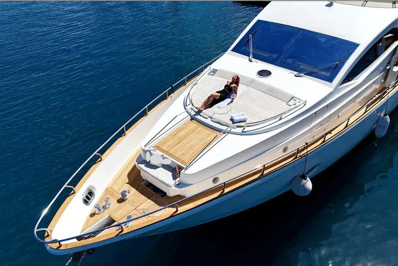 Red Rose Yacht Photos Pics Luxurious 2010 Aicon 85 yacht with sunbathing area on calm blue waters.