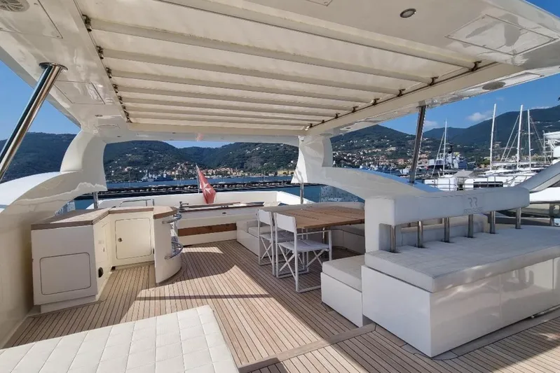 Red Rose Yacht Photos Pics Luxurious 2010 Aicon 85 yacht deck with seating, dining area, and scenic marina view.