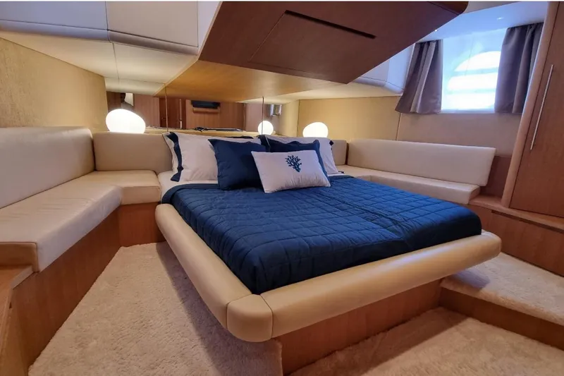 Red Rose Yacht Photos Pics Luxurious bedroom interior of 2010 Aicon 85 yacht with elegant bedding and ambient lighting.