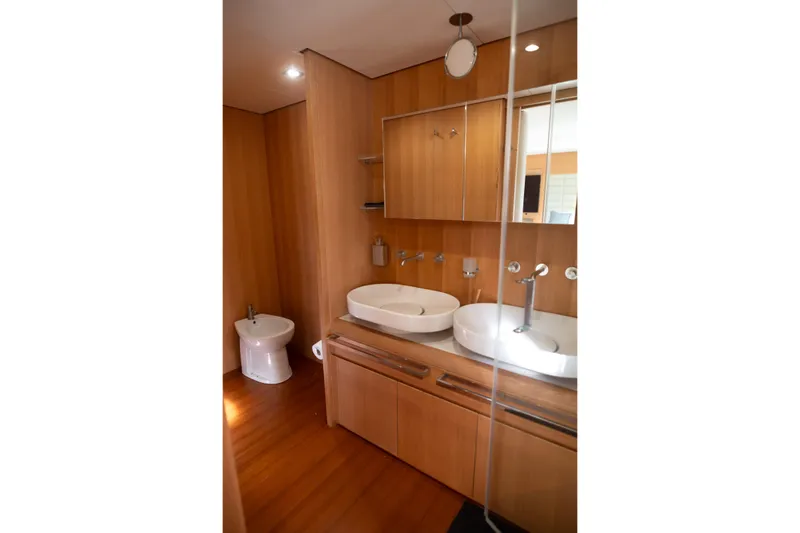 Red Rose Yacht Photos Pics Luxurious wooden bathroom interior on 2010 Aicon 85 yacht with dual sinks and modern fixtures.