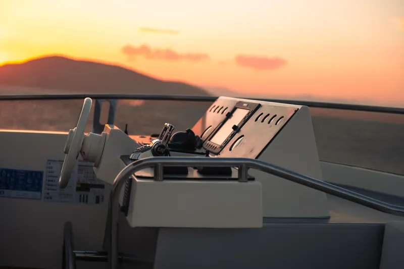 Red Rose Yacht Photos Pics Helm of 2010 Aicon 85 yacht at sunset, featuring modern controls and serene ocean view.