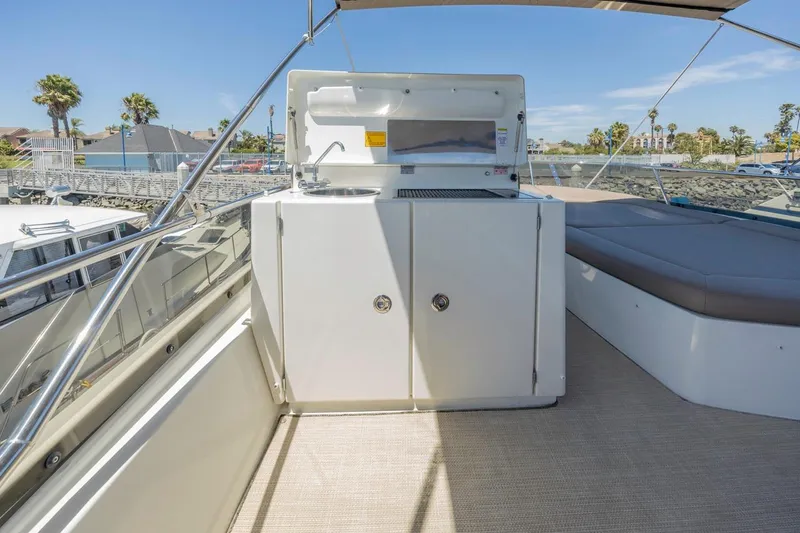 Shanti Yacht Photos Pics Flybridge of 2015 Prestige 500FB yacht with outdoor kitchen and seating area.