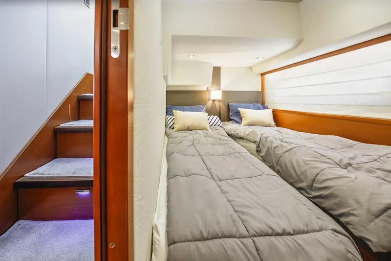 Shanti Yacht Photos Pics Twin beds in a cozy cabin of a 2015 Prestige 500FB yacht.