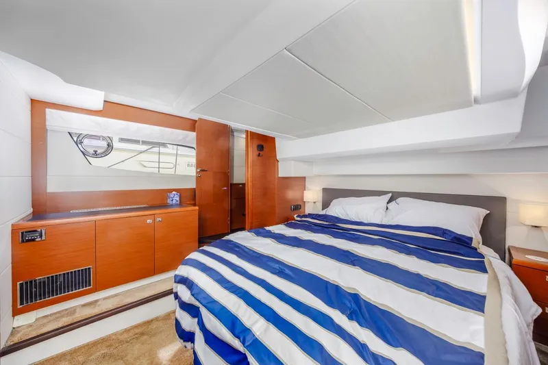 Shanti Yacht Photos Pics Luxurious cabin interior of 2015 Prestige 500FB yacht with striped bedding and wooden accents.