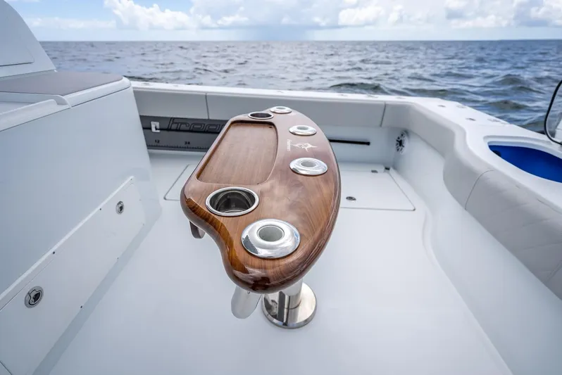  Yacht Photos Pics 2023 Freeman 43 boat with sleek wooden fishing station, cup holders, and ocean backdrop.
