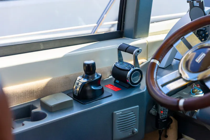 Boat Yacht Photos Pics Cockpit controls of a 2011 Azimut 68S yacht, featuring steering wheel and throttle levers.