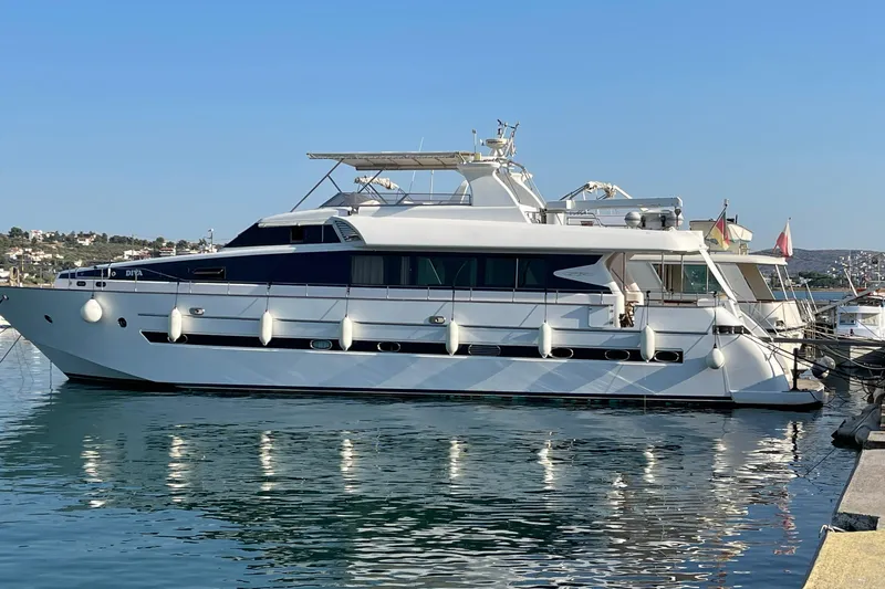  Yacht Photos Pics Luxurious 1995 PR Marine 82 yacht docked in a serene marina setting.