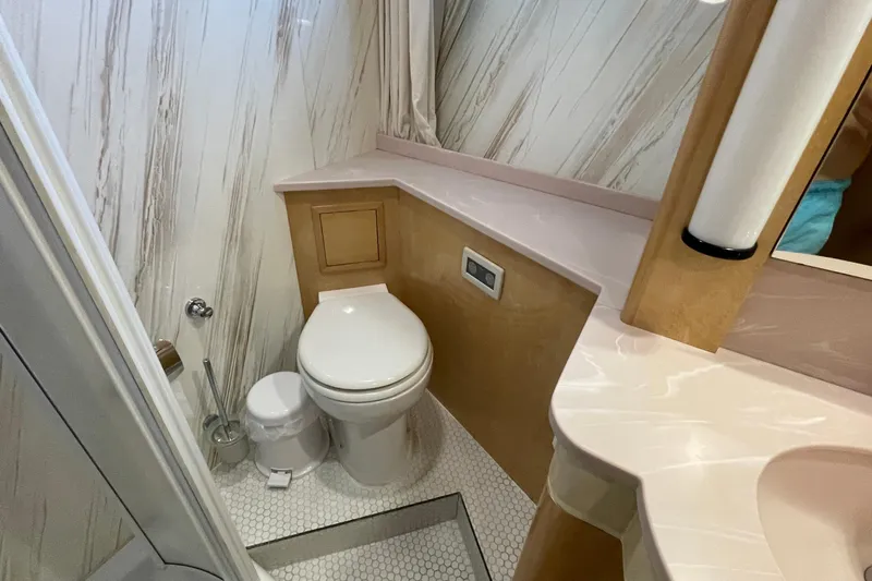  Yacht Photos Pics Compact bathroom in a 1995 PR Marine 82 yacht with modern fixtures and marble accents.