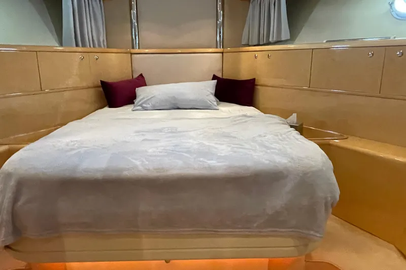  Yacht Photos Pics Luxurious bedroom interior of 1995 PR Marine 82 yacht with elegant bedding and ambient lighting.