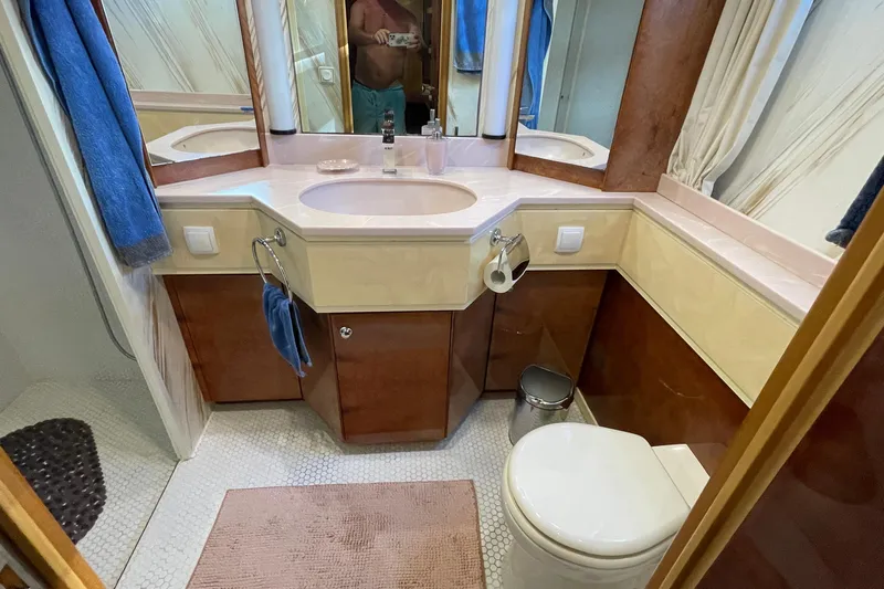  Yacht Photos Pics Luxurious bathroom in 1995 PR Marine 82 yacht with elegant fixtures and wood accents.