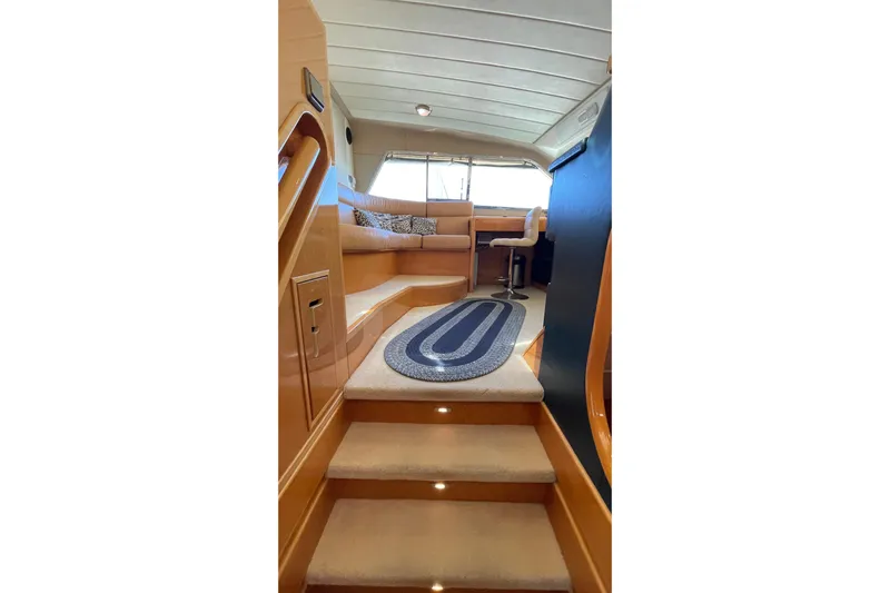  Yacht Photos Pics Interior of 1995 PR Marine 82 yacht with carpeted stairs and seating area.
