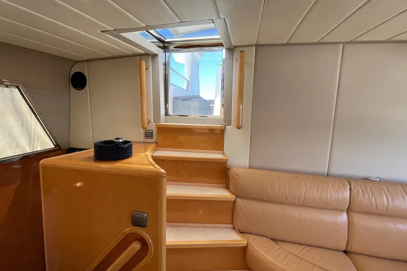  Yacht Photos Pics Interior of 1995 PR Marine 82 yacht with wooden stairs and leather seating.