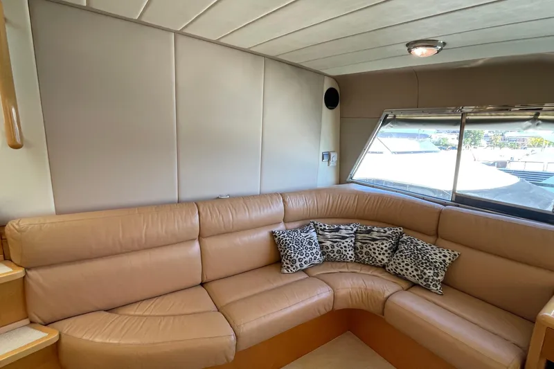  Yacht Photos Pics Luxurious interior of 1995 PR Marine 82 yacht with beige leather seating and patterned cushions.
