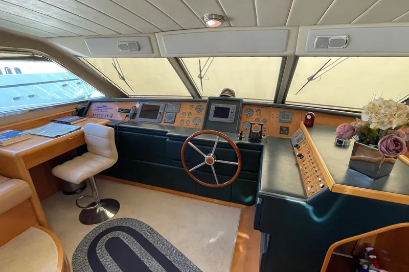  Yacht Photos Pics Interior of 1995 PR Marine 82 yacht cockpit with steering wheel and control panel.