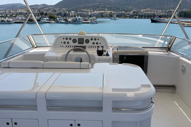  Yacht Photos Pics Cockpit view of 1995 PR Marine 82 yacht with scenic harbor backdrop.
