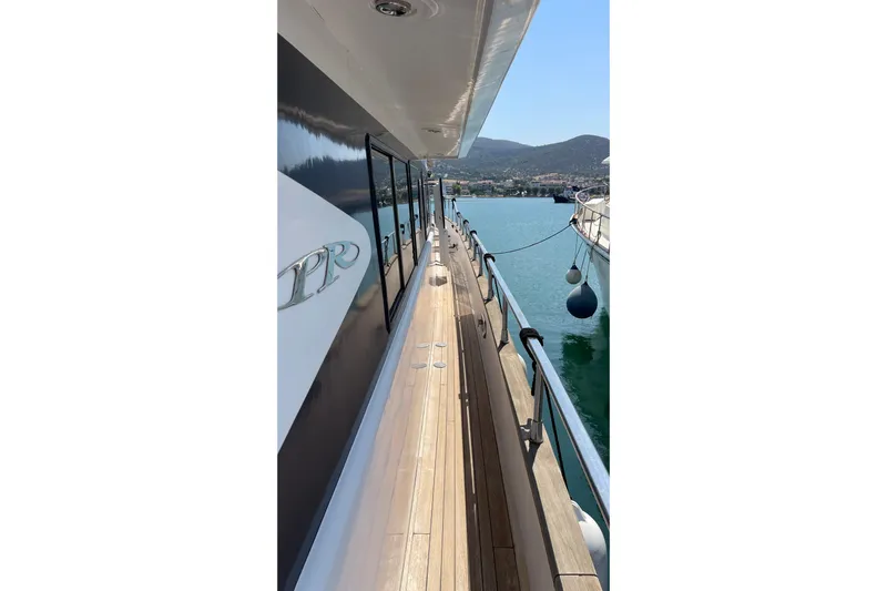  Yacht Photos Pics Side view of a 1995 PR Marine 82 yacht docked in a serene harbor.