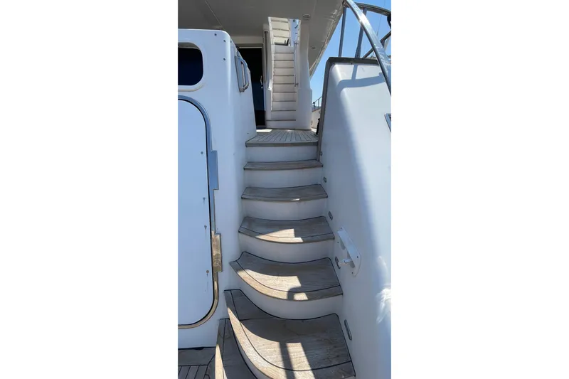  Yacht Photos Pics Staircase on 1995 PR Marine 82 yacht, featuring sleek design and wooden steps.