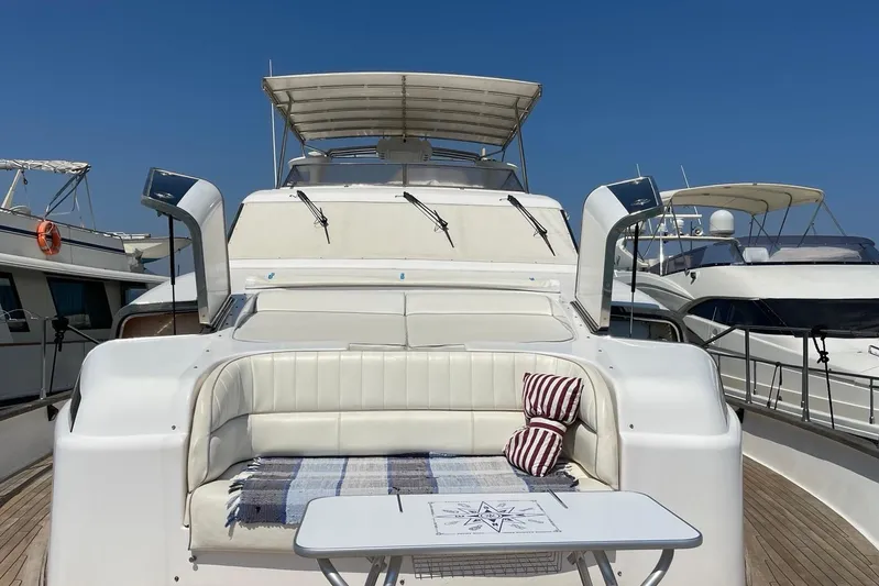  Yacht Photos Pics Luxurious 1995 PR Marine 82 yacht with elegant seating and table on deck.