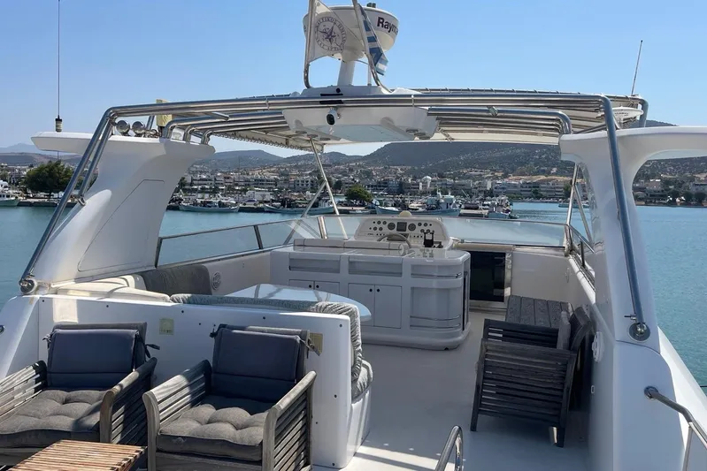  Yacht Photos Pics Luxurious 1995 PR Marine 82 yacht with spacious deck and scenic harbor view.