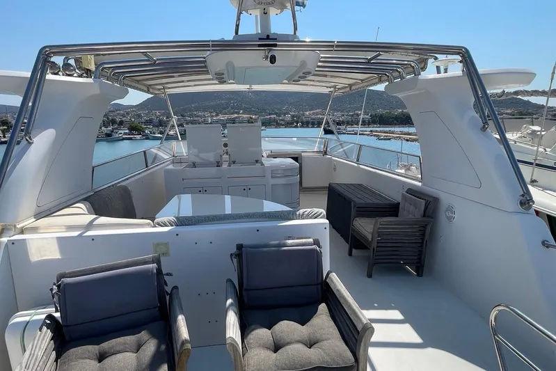  Yacht Photos Pics Luxurious 1995 PR Marine 82 yacht deck with seating, overlooking serene marina waters.