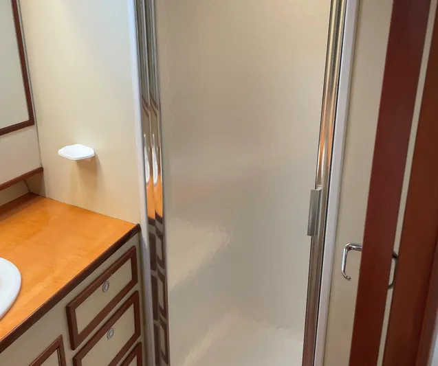Red Witch Yacht Photos Pics Bathroom interior of 2001 Custom Carolina Lydia 57 Sportfish with shower and wooden cabinetry.