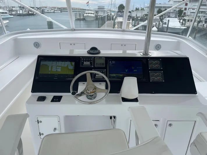Red Witch Yacht Photos Pics Helm of 2001 Custom Carolina Lydia 57 Sportfish with navigation screens and steering wheel.