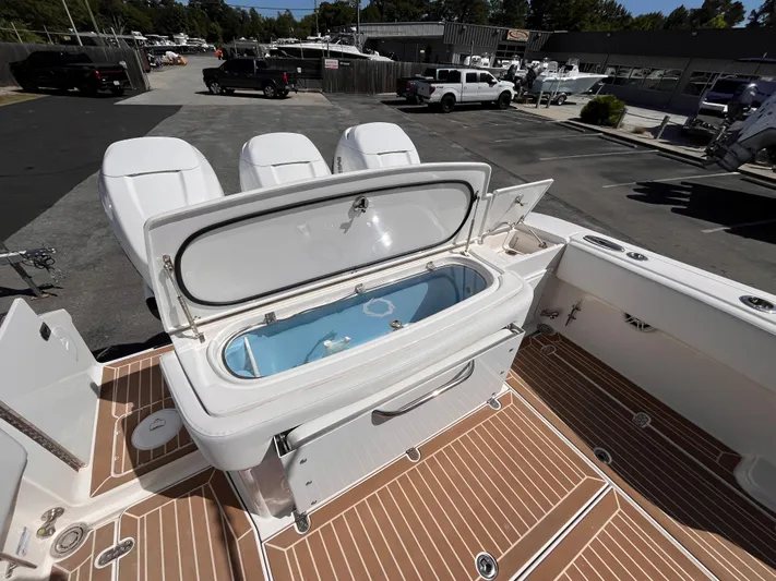  Yacht Photos Pics 2021 Fountain 38 SFC boat with open livewell on deck, showcasing seating and storage.