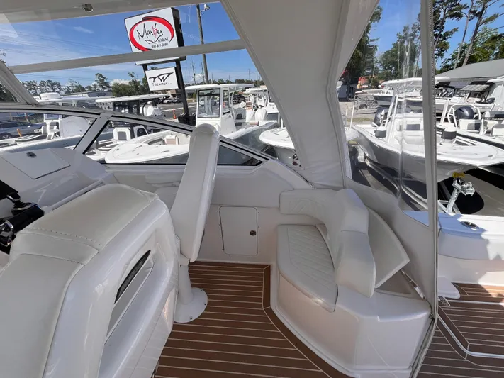  Yacht Photos Pics Interior of 2021 Fountain 38 SFC boat with white seating and wood flooring.