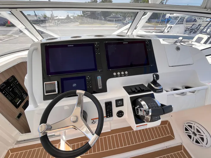  Yacht Photos Pics Helm of 2021 Fountain 38 SFC boat with dual screens and modern controls.
