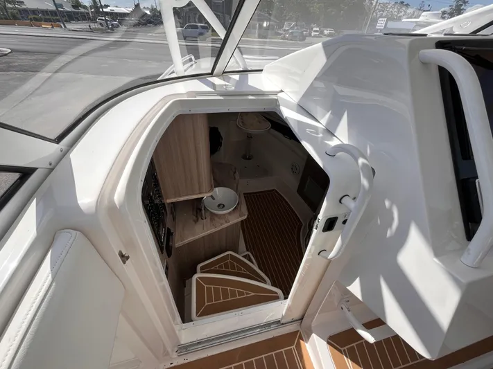  Yacht Photos Pics Interior view of 2021 Fountain 38 SFC boat cabin with wooden flooring and compact design.