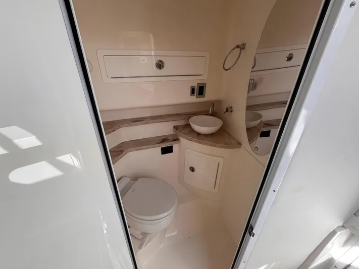  Yacht Photos Pics 2021 Fountain 38 SFC boat bathroom with modern fixtures and compact design.