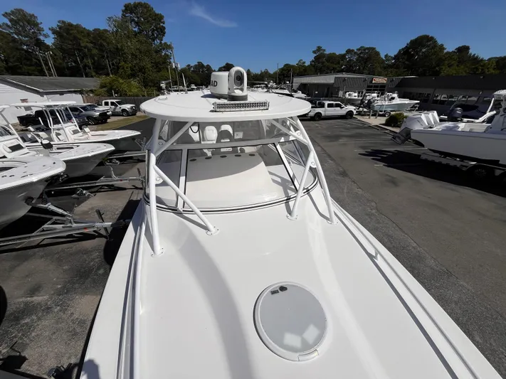  Yacht Photos Pics 2021 Fountain 38 SFC boat on display at a dealership, surrounded by other boats.