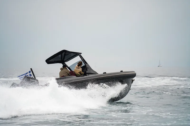 Rock Marine Rm 30 Yacht Photos Pics 2026 Rock Marine RM 30 boat navigating waves, featuring a Greek flag.