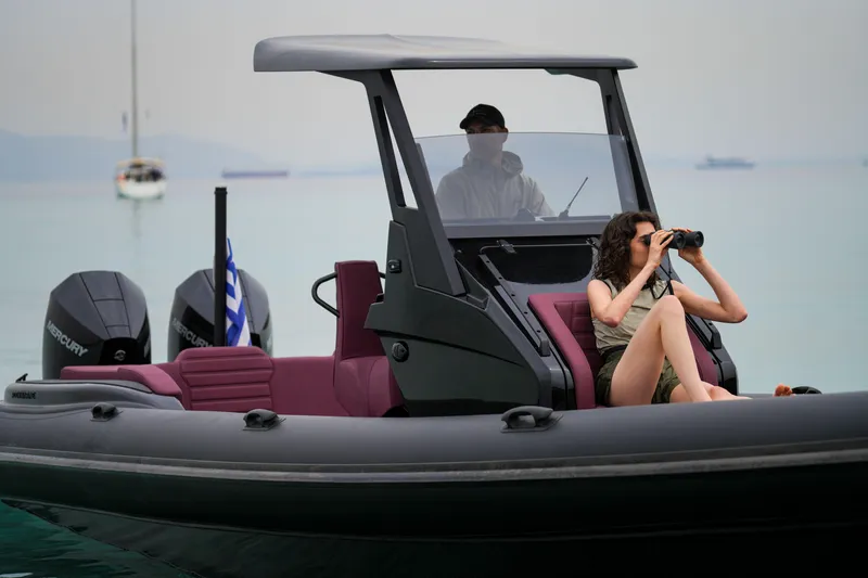 Rock Marine Rm 30 Yacht Photos Pics 2026 Rock Marine RM 30 boat with passengers, one using binoculars, on calm water.