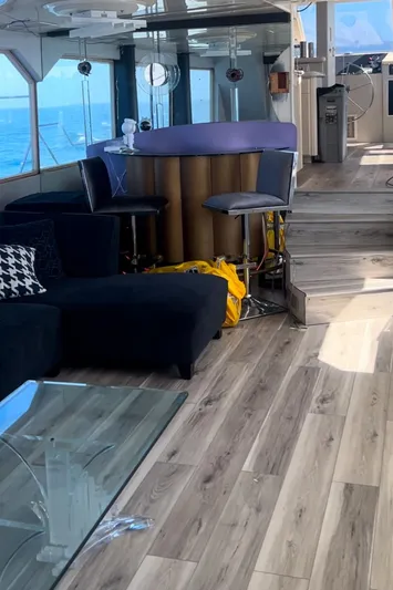 Scherzo Yacht Photos Pics Luxurious yacht interior with modern bar, seating, and ocean view, 1989 custom model.