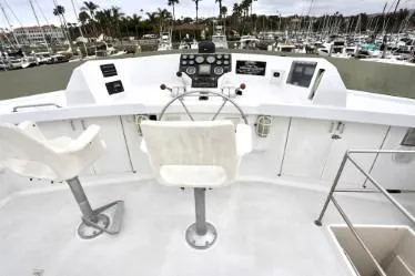 Scherzo Yacht Photos Pics Helm of 1989 custom boat with dual seats and marina view.