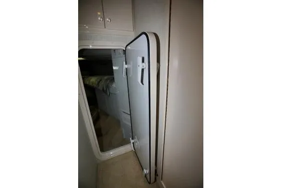 Scherzo Yacht Photos Pics Hatch door in a custom 1989 vehicle interior, partially open, revealing a cabin space.