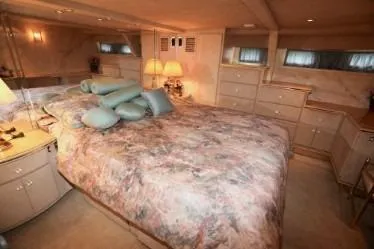 Scherzo Yacht Photos Pics Luxurious 1989 custom bedroom with plush bedding, soft lighting, and elegant decor.