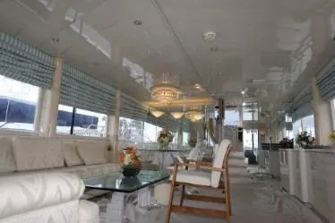 Scherzo Yacht Photos Pics Luxurious yacht interior with elegant seating, glass table, and chandeliers, Custom model, 1989.