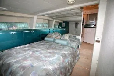 Scherzo Yacht Photos Pics 1989 custom interior with bed, teal cabinets, and cozy decor.