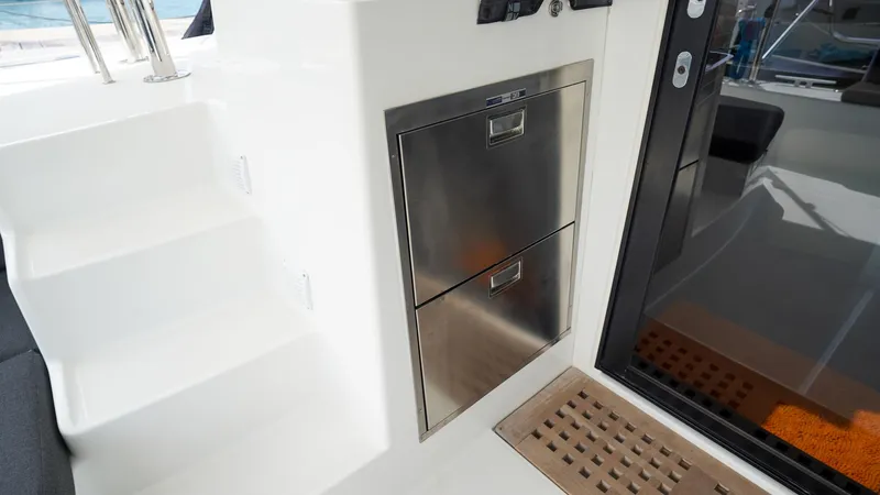 Good Times And Tan Lines Yacht Photos Pics Interior of 2023 Lagoon 42 yacht featuring stainless steel storage and sleek design elements.