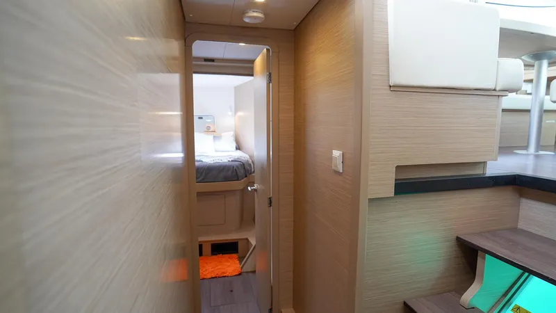 Good Times And Tan Lines Yacht Photos Pics Interior of 2023 Lagoon 42 catamaran, featuring a cozy cabin and modern design elements.