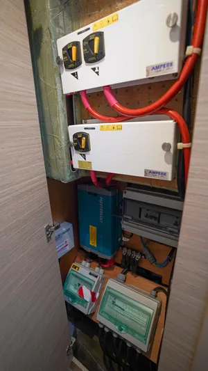 Good Times And Tan Lines Yacht Photos Pics Electrical panel inside 2023 Lagoon 42 yacht, featuring switches and wiring.