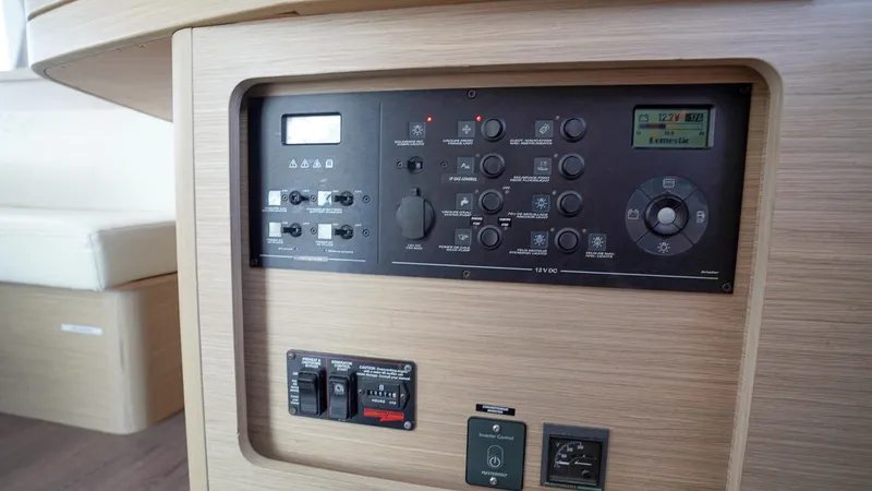 Good Times And Tan Lines Yacht Photos Pics Control panel of a 2023 Lagoon 42 yacht, featuring various switches and dials.