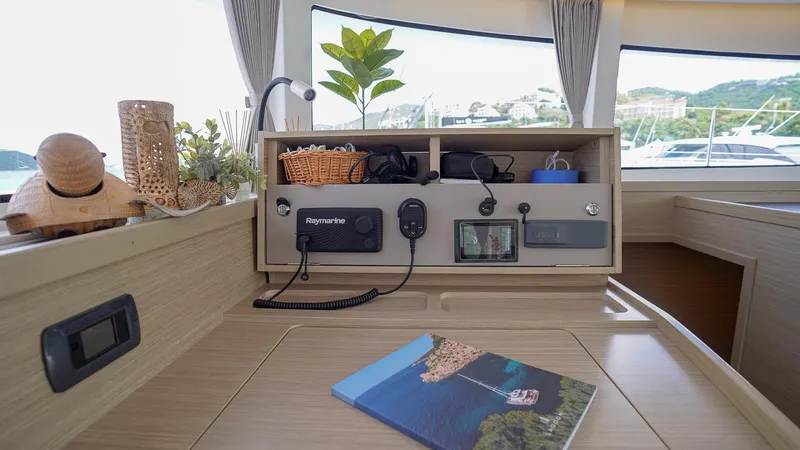 Good Times And Tan Lines Yacht Photos Pics Interior of 2023 Lagoon 42 yacht with navigation equipment and decor.