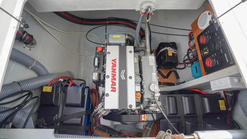Good Times And Tan Lines Yacht Photos Pics Engine compartment of a 2023 Lagoon 42 catamaran with Yanmar engine and battery setup.