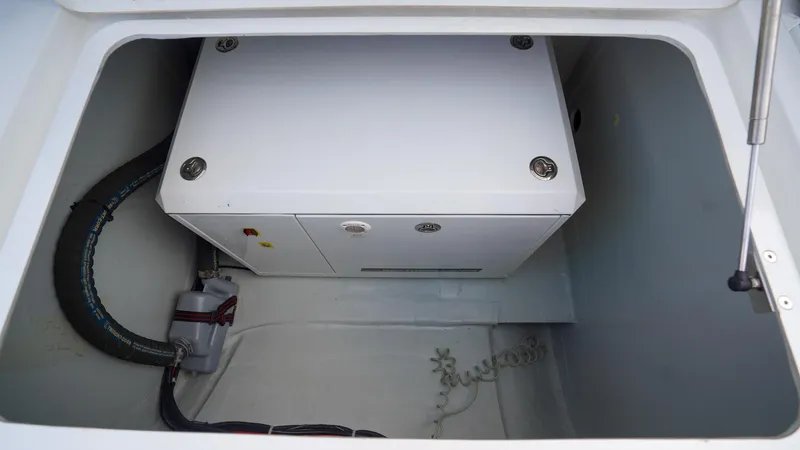 Good Times And Tan Lines Yacht Photos Pics 2023 Lagoon 42 yacht compartment with equipment and wiring.