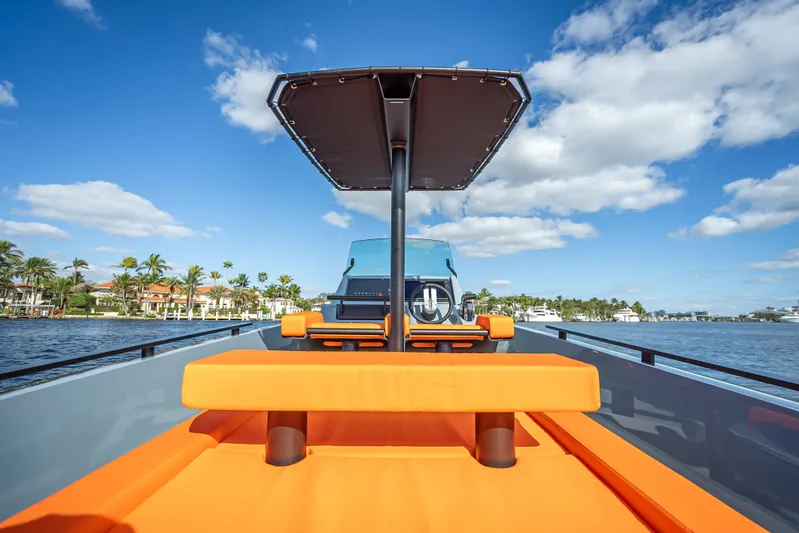  Yacht Photos Pics 2024 Goldfish 28 Tender boat with orange seating and canopy on a sunny day.