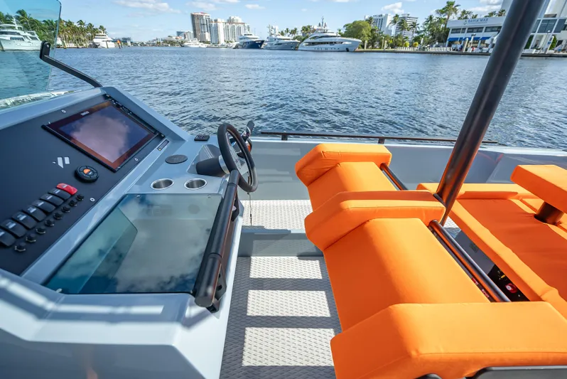  Yacht Photos Pics 2024 Goldfish 28 Tender boat interior with orange seats and modern dashboard.